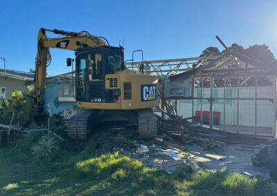 Excavator demolishing a residential property in South East Queensland