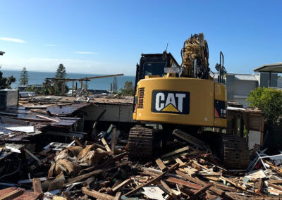 Clean excavation site following demolition and debris removal
